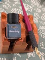 Ink bottle and dip pen on stand